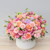 Pink and peach bouquet in a white ribbed vase