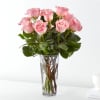 Pink roses arranged in a clear glass vase