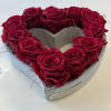 Heart-shaped box filled with red roses