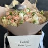 Bouquet of blush and cream roses with white blooms in a gift box