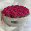 Hot pink roses arranged in a round gray container