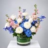 Blue and white floral arrangement in a glass vase