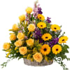 A white wicker basket filled with a beautiful selection of yellow and