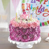 Pink and purple flower cake with birthday candles and a balloon
