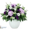 Lavender and white roses arranged in a white vase