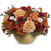 Peach roses and orange mums in a textured gold vase