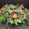 Succulents and berries and greenery with wax flower accents 
