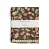 Folded tea towel with an oak leaf and acorn pattern