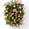 Soft and inviting, this pastel standing spray offers a gentle expression of