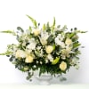 Designed to surround the urn with understated elegance, this best-selling all-white arrangement