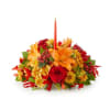 Autumn floral centerpiece with a red taper candle