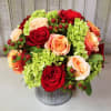 A simple arrangement of fall roses, hydrangeas and berries, perfect for any