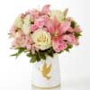 Pink and cream bouquet in a white vase with a gold dove design