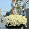 Large basket of cream roses with a white ribbon