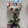 Birthday balloon with a potted peace lily and a candle