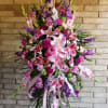 Large standing spray of pink and purple lilies and carnations