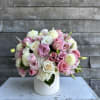 Pink and white bouquet in a white vase