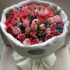 Bouquet of pink and red tulips wrapped in white paper