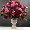 Red and pink rose bouquet in a white pedestal vase
