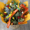Bouquet of multicolored tulips in a wicker basket with bird decorations