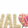 Floral letters spelling "A" and "L" beside a heart-shaped pink flower arrangement