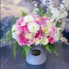 Pink and white rose bouquet in a gray hat box