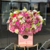 Large pink and white rose arrangement in a pink box