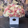Large pastel bouquet of pink and white roses in a white box