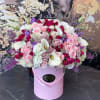 Pink and white rose bouquet with calla lilies in a pink hatbox