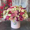 Large pink and cream rose arrangement in a pale box