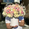 Large pastel bouquet of roses and pink anemones in a white hat box