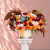 Large mixed bouquet of roses and mums in a white vase