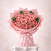Bouquet of pink roses wrapped in pink paper with a ribbon