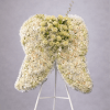 Large standing arrangement of white and cream flowers shaped like angel wings on a white easel.