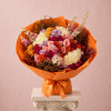 Mixed bouquet of colorful roses wrapped in bright orange paper