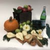 Fruit and snack gift arrangement with a pumpkin and flowers
