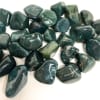 Pile of polished dark green stones on a white background