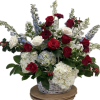 Basket arrangement of red and white roses with blue and white flowers