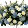 Blue hydrangeas and white roses arranged in a low centerpiece