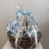Gift basket wrapped in clear cellophane with a blue ribbon