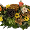 Long and low centerpiece with assorted fall flowers. 