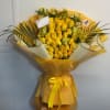 Yellow rose bouquet wrapped in yellow paper with a ribbon