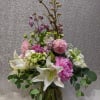 Pink and white floral arrangement in a glass vase