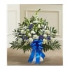White and blue floral standing spray with a blue ribbon