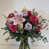 A stunning floral arrangement of purple and pink blooms, gracefully intertwined to