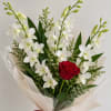 Bouquet of white orchids and a red rose wrapped in clear paper