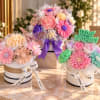 Three colorful flower gift boxes with birthday decorations
