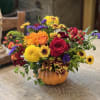 Colorful mixed bouquet in a small orange pumpkin container