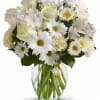 White bouquet of roses and daisies in a clear glass vase