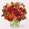 Bouquet of red and orange flowers in a clear glass vase